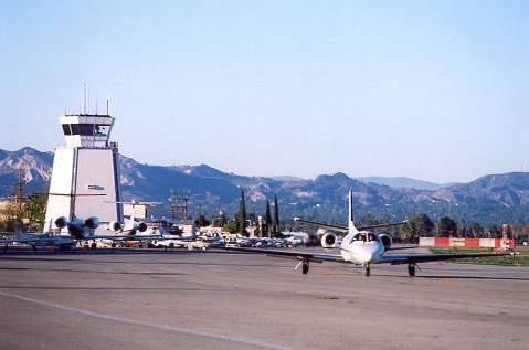 Van Nuys Airport control tower with the San Gabriel Mountains behind it